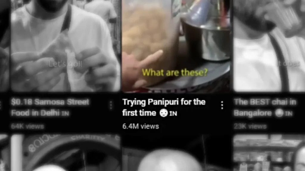 Una miniatura de YouTube Shorts muestra una mano señalando un recipiente de panipuri con la leyenda "¿Qué es esto?" y el título "Probando el panipuri por primera vez", con el objetivo de obtener virales.